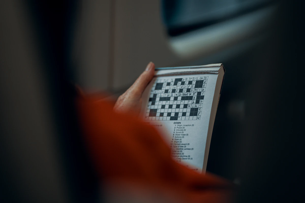 Person holding a crossword puzzle