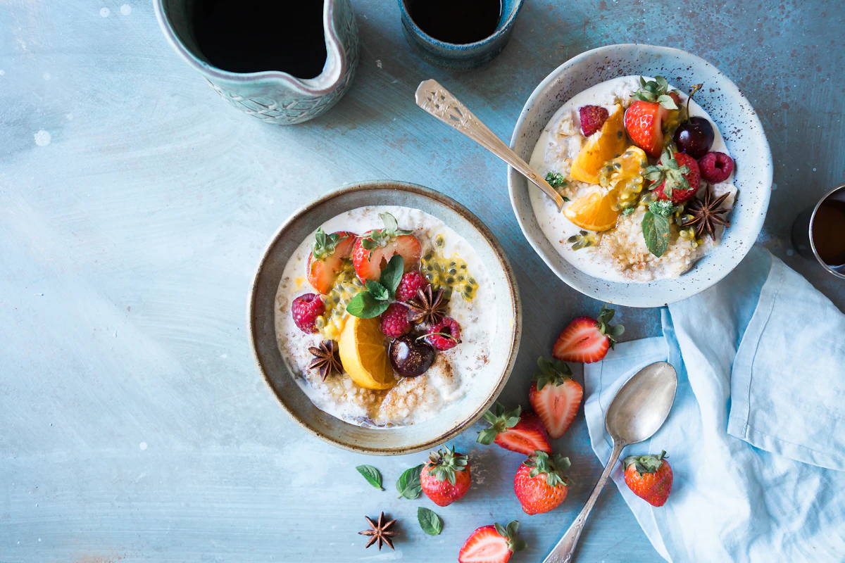 Two bowls of oatmeal with fruits