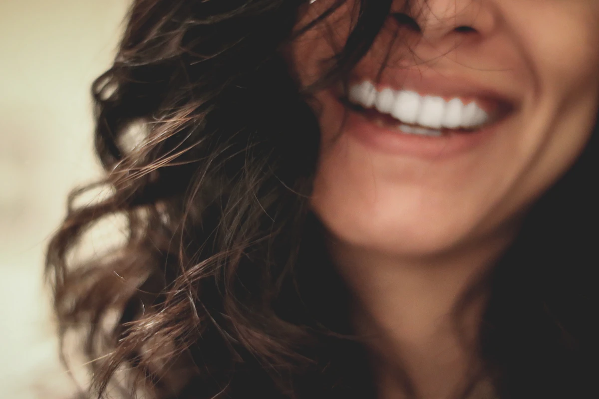 Long black haired woman smiling, close-up