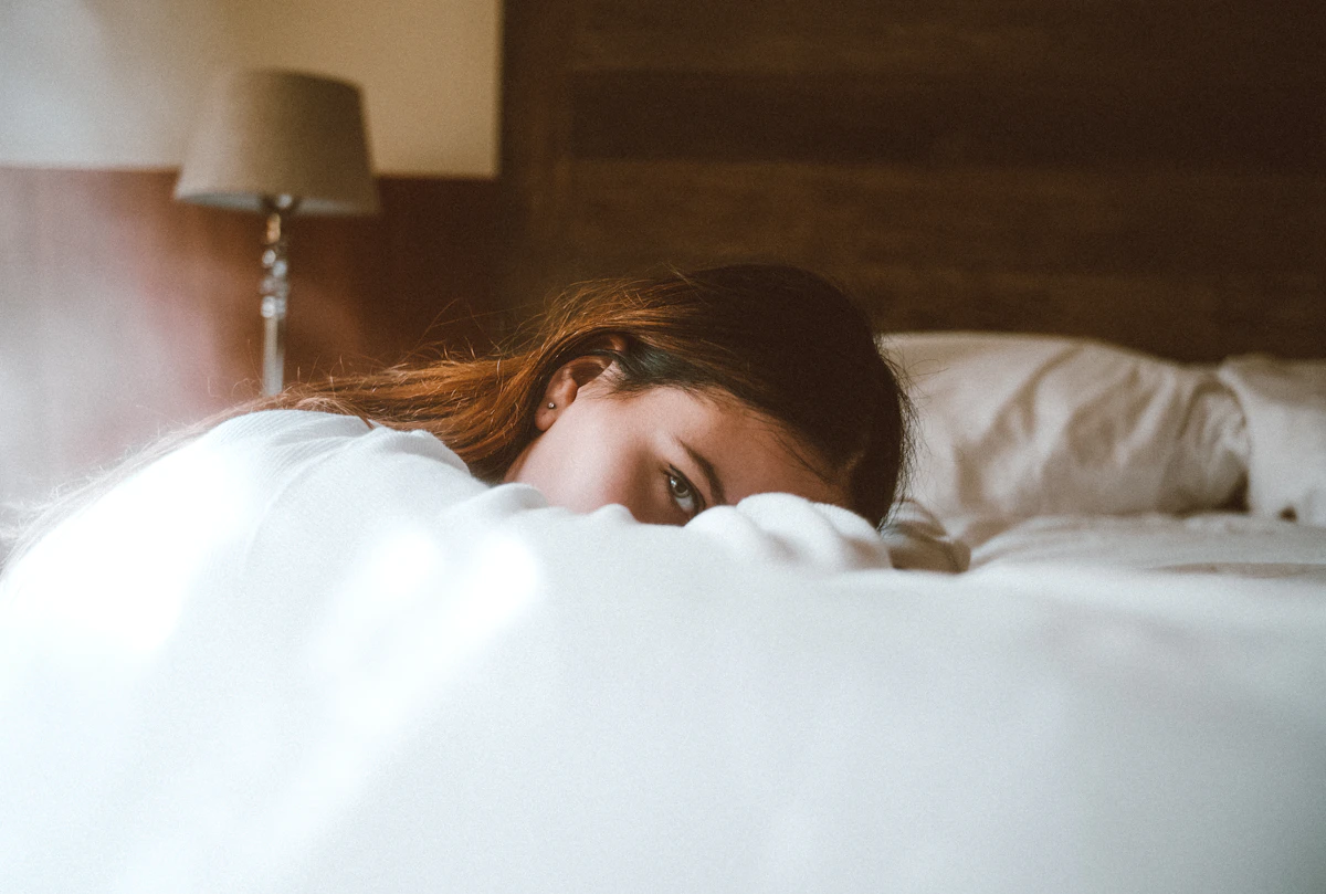Woman resting her head on the bed