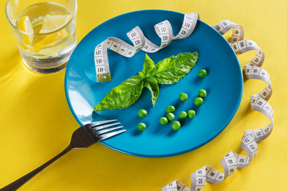 A blue plate with green vegetables and a measuring tape