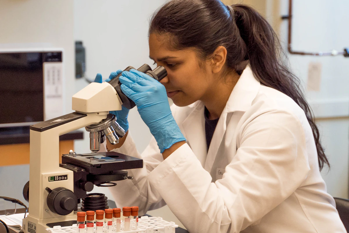 Woman looking into a microscope
