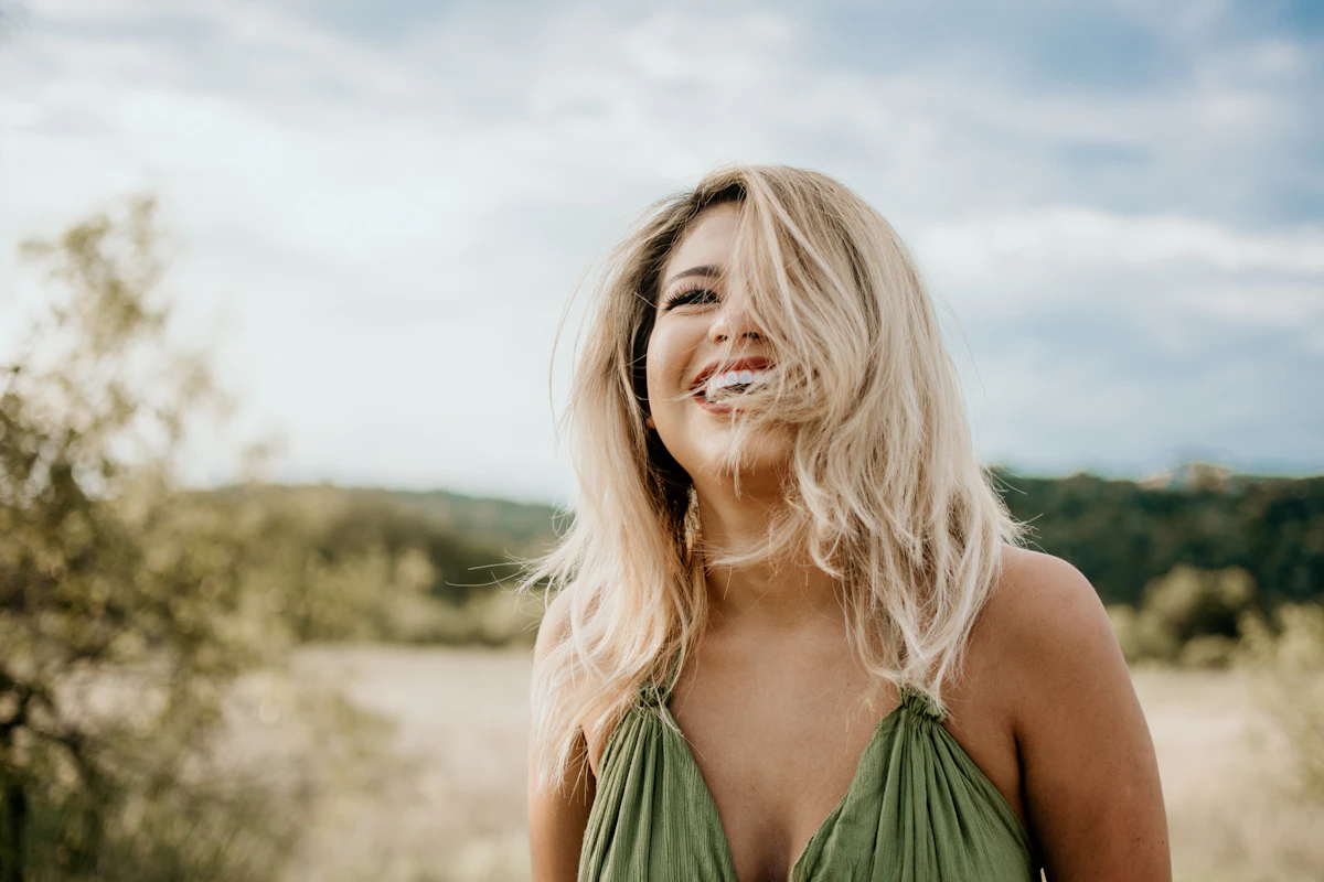 Laughing woman with her hair blowing across her face