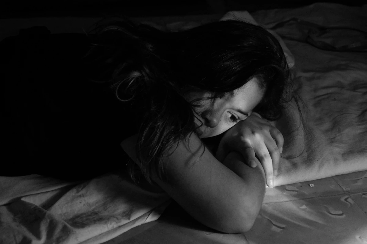 Woman leaning on her bed