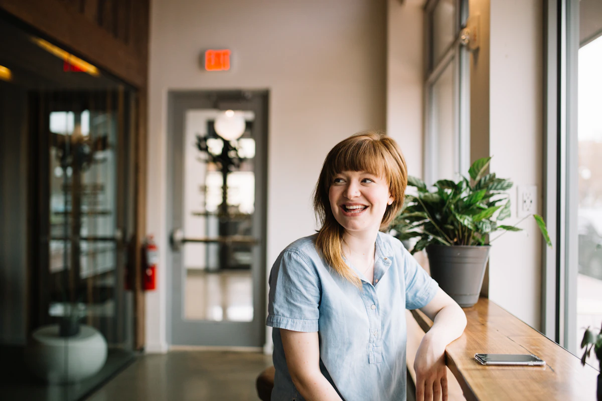 Smiling woman sitting at a wooden table