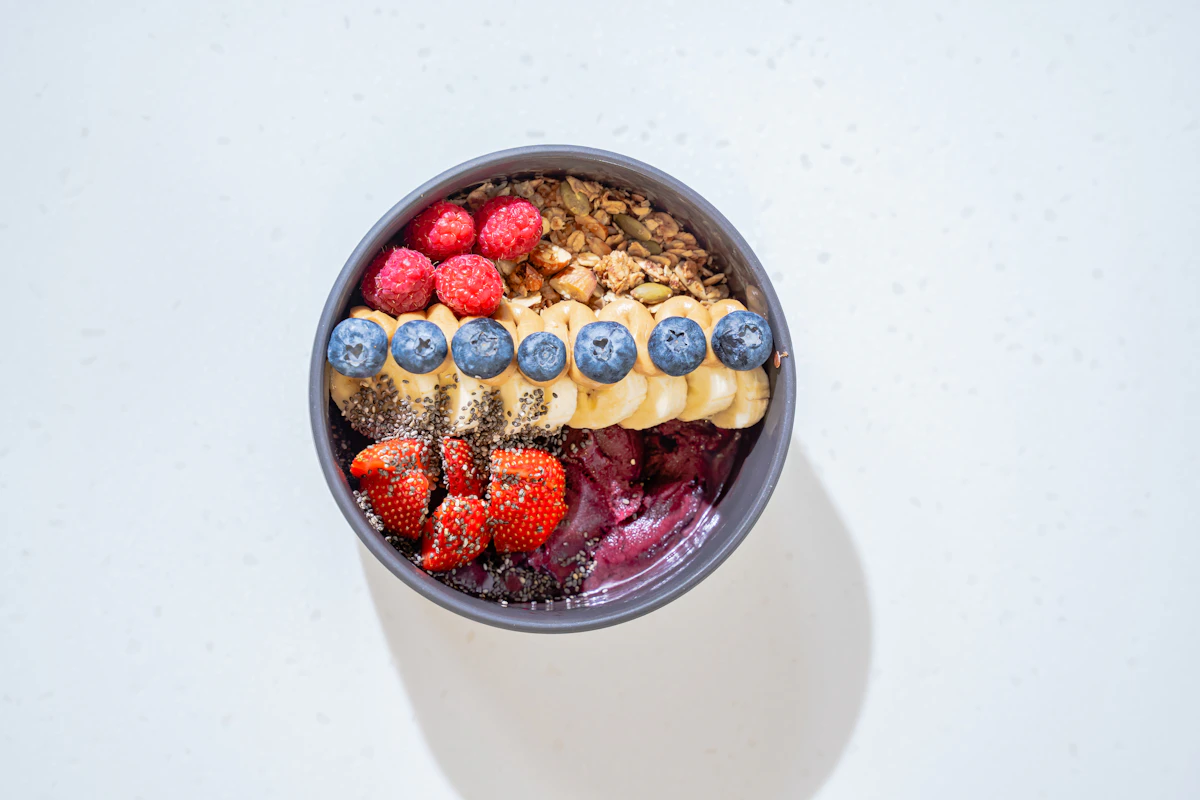 A bowl of cereal with milk and fruit
