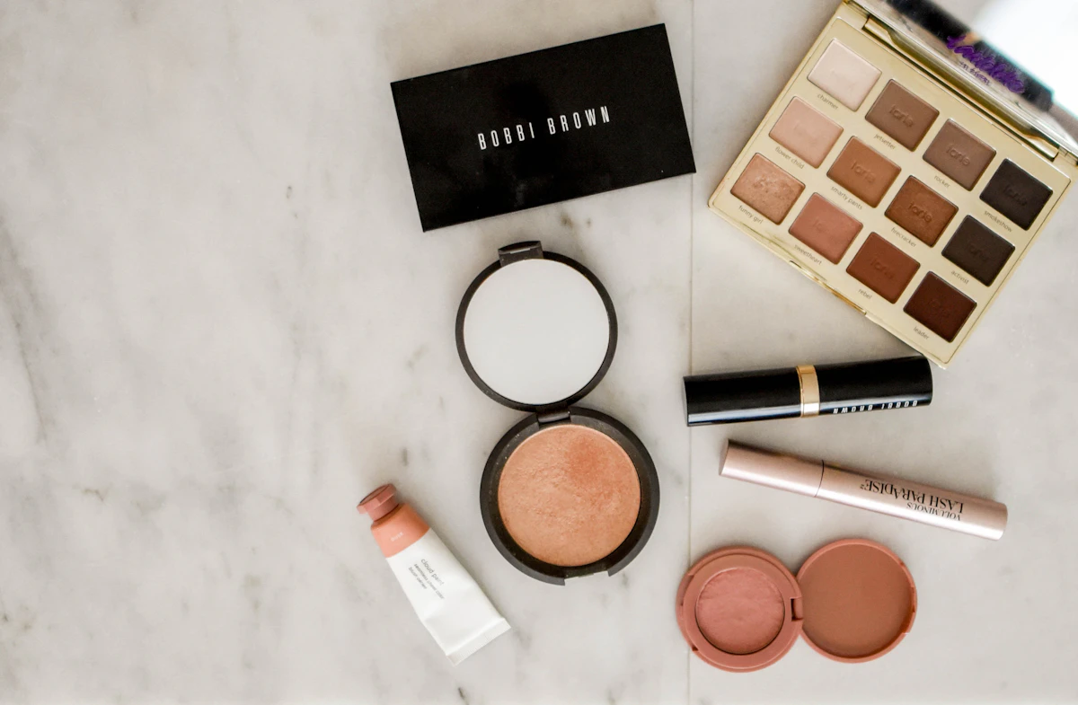 A ssorted makeup products on a gray surface
