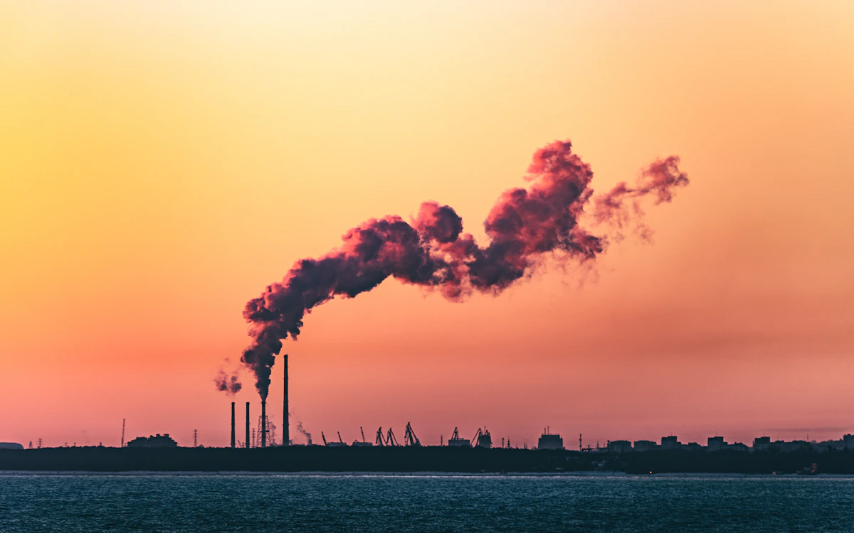Smokestacks against an orange sunset