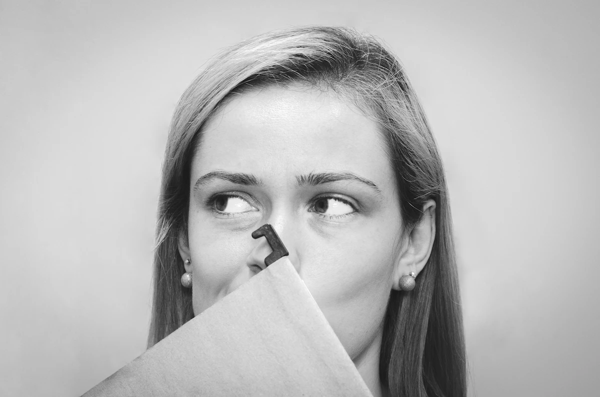 Woman covering her nose with a tissue